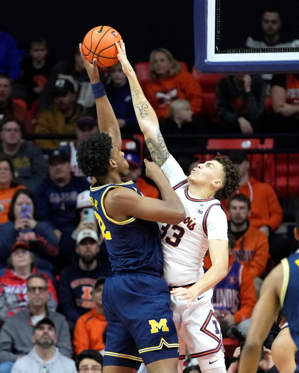 Illinois' Coleman Hawkins (33) blocks the shot of Michigan's Tarris Reed Jr. during the first half at State Farm Center in Champaign, Illinois, on Tuesday, Feb. 13, 2024.