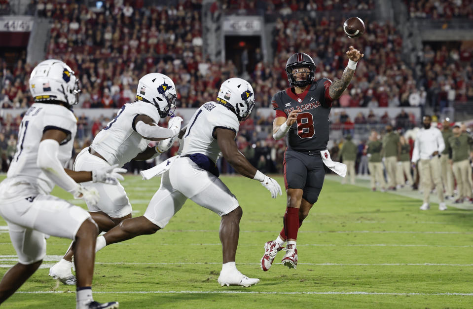 Oklahoma quarterback Dillon Gabriel (8) passes against West Virginia during the first half of an NCAA college football game Saturday, Nov. 11, 2023, in Norman, Okla. (AP Photo/Alonzo Adams)