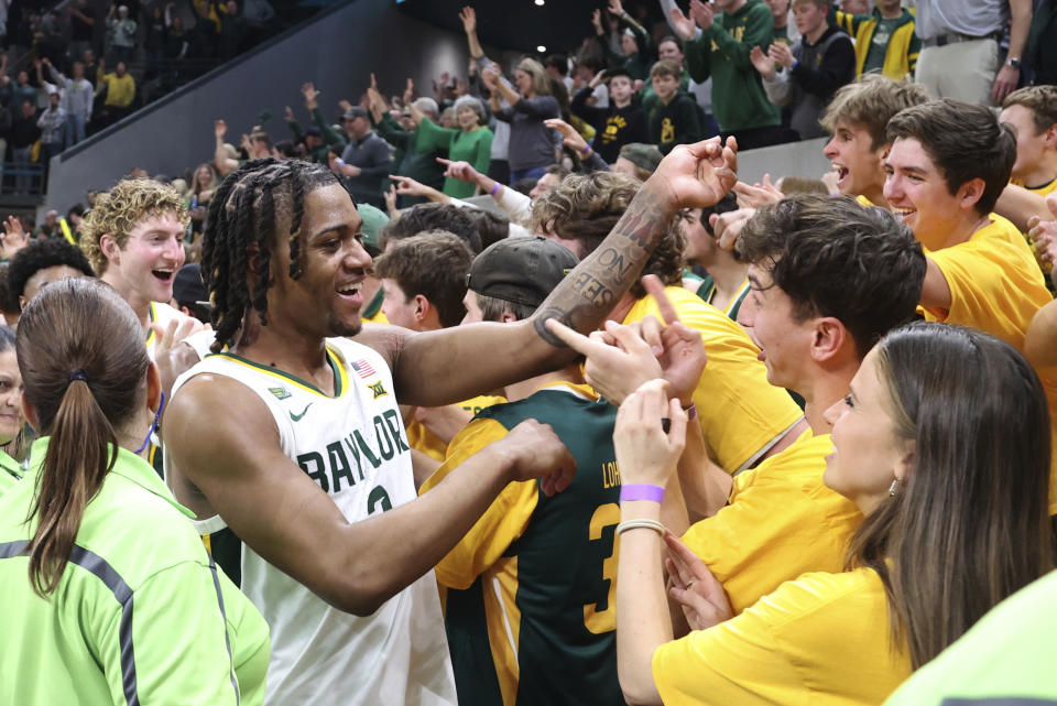 Baylor guard Jayden Nunn, second from front left, celebrates with students after defeating Iowa State following an NCAA college basketball game, Saturday, Feb. 3, 2024, in Waco, Texas. Nunn scored the go head basket to win the game. (AP Photo/Rod Aydelotte)