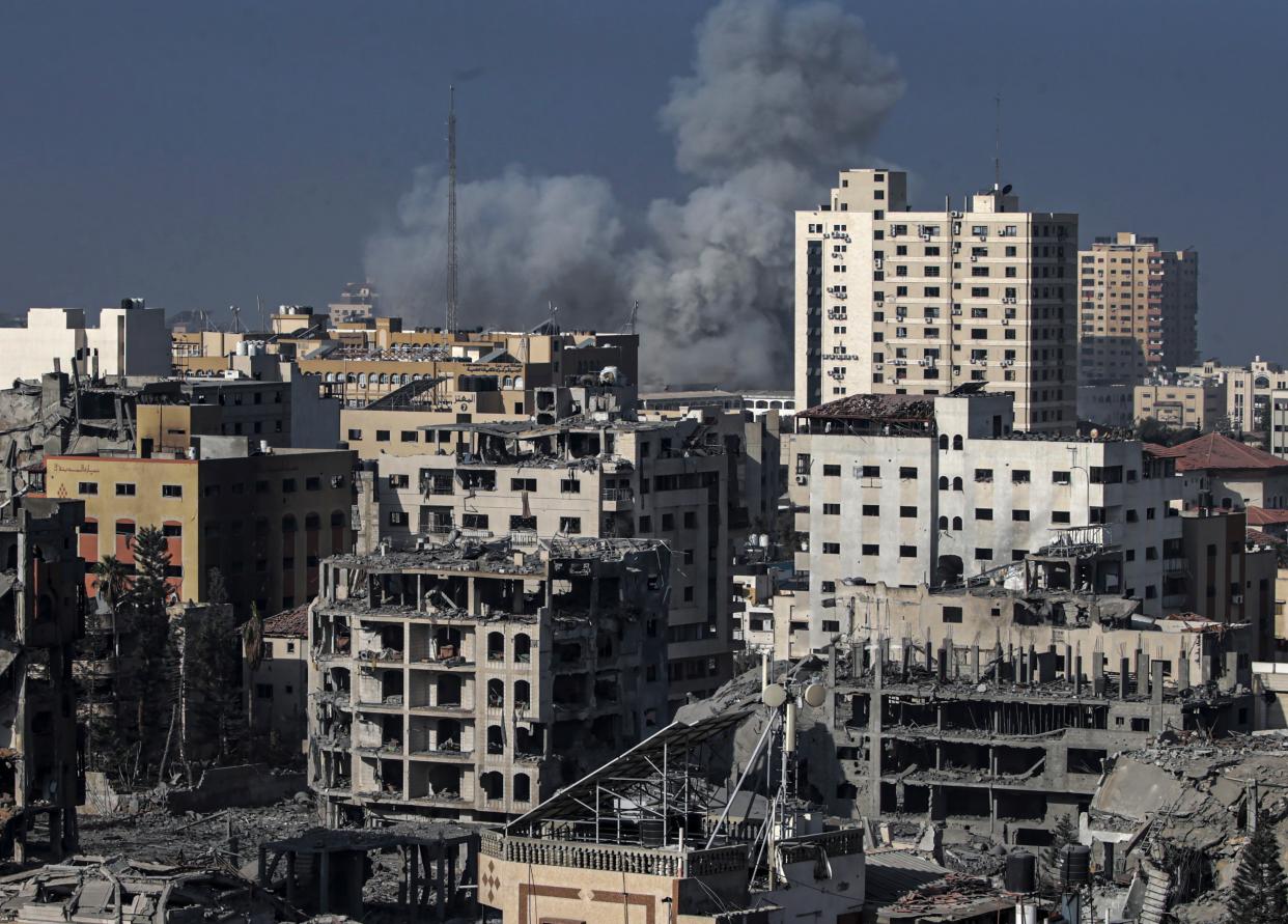 Smoke is seen rising above the Gaza cityscape following Israeli airstrikes (AP)