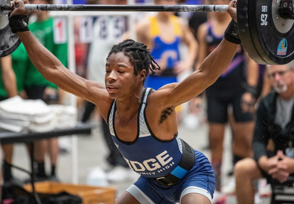 Ridge Community High School A-Jay Saint Louis makes a lift during the 3A State Weightlifting Championship at the RP Funding Center in Lakeland on Friday.
