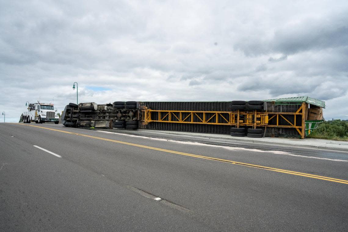 The semi-truck was traveling north over I-5 Tuesday morning when it flipped on its side. Fife police said another truck flipped at this same location Sunday.