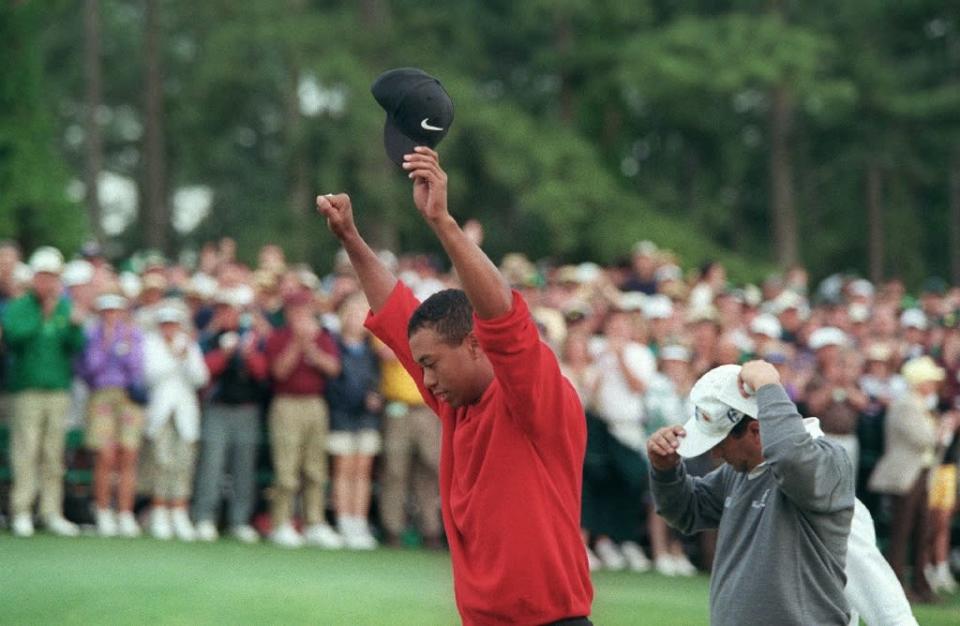 Tiger Woods raises his arms in victory after winning the 1997 Masters tournament, a turning point for the sport, the man and even the course (AFP Photo/JEFF HAYNES)
