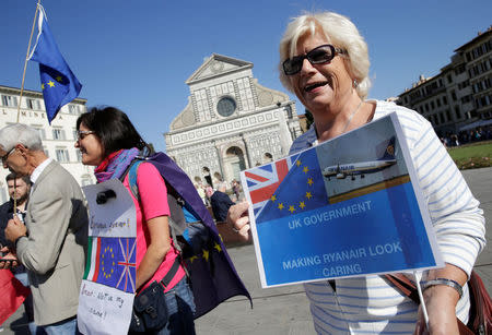 A woman holds up a placard ahead of a speech by Britain's Prime Minister Theresa May in Florence, Italy September 22, 2017. REUTERS/Max Rossi