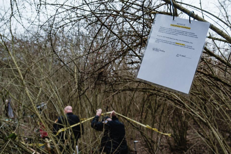 New Philadelphia Police officers posted a notice of trespass warning to people occupying what the city has deemed a homeless encampment on a piece of land off Fourth Street Extension SE, Wednesday, Jan. 31 in New Philadelphia.