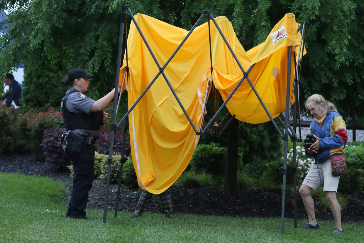 Officer H. Yarborough and Judy Ford help fold up tents as rain caused the cancellation of the Kings Mountain 150th Birthday Bash Saturday, May 4, 2024.