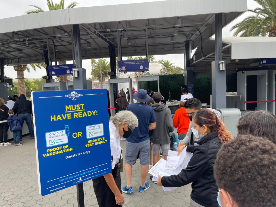 entrance gate to universal studios hollywood with people scanning tickets