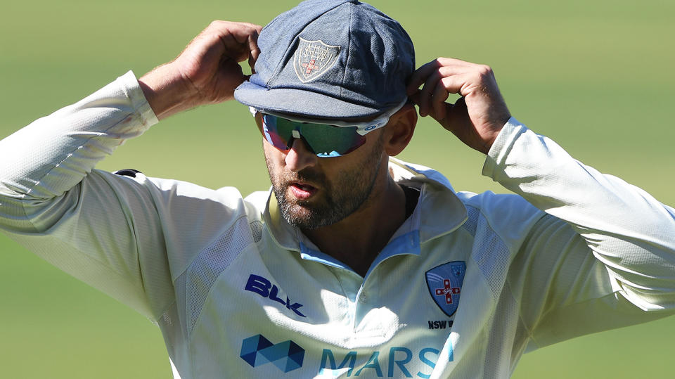 Nathan Lyon (pictured) fixes his hat during the Sheffield Shield.