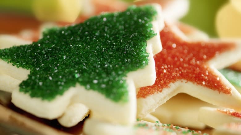 Two Christmas sugar cookies decorated with red and green sprinkles