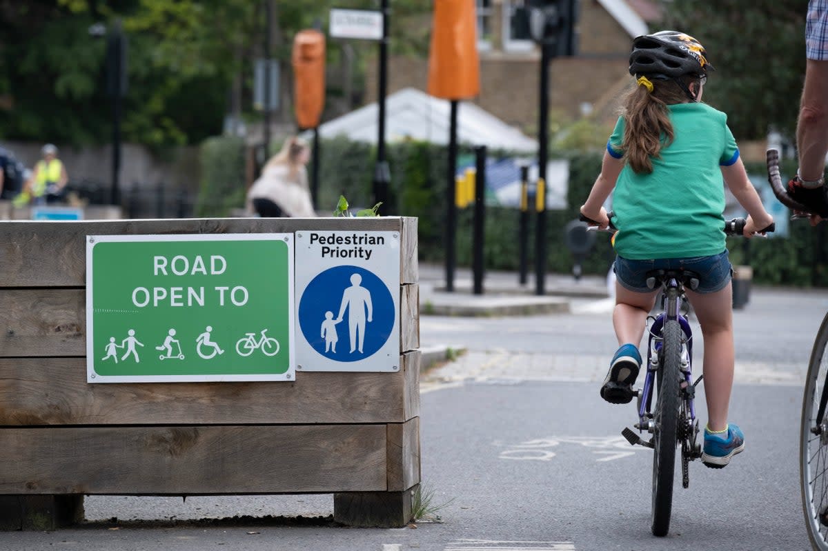 A young cyclist passes through the barriers that form a Low Traffic Neighbourhood (Richard Baker / In Pictures via Getty Images)