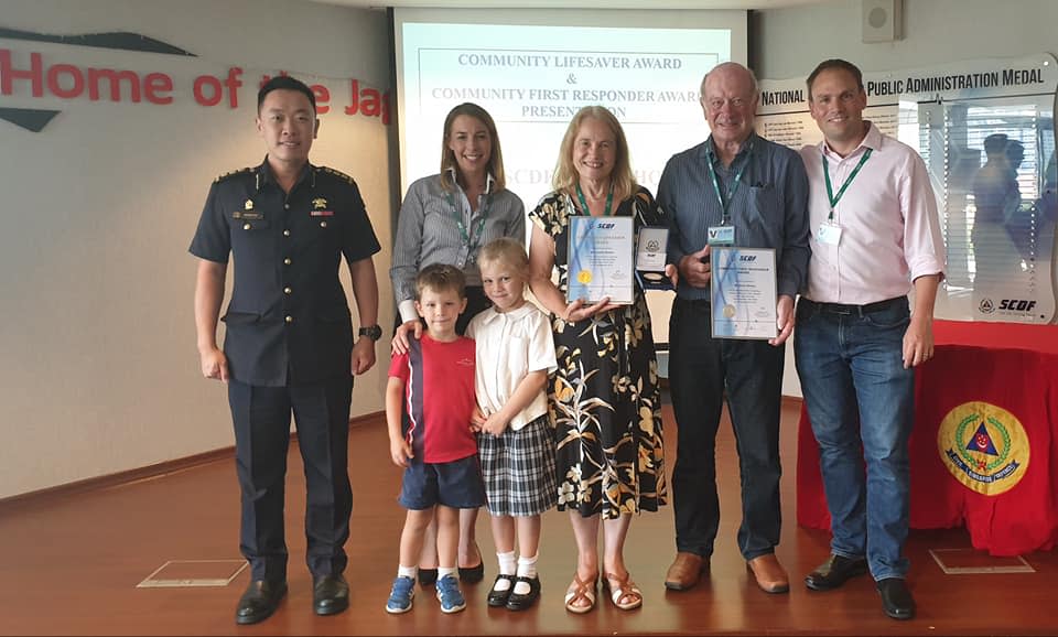 The Brewins (posing with their awards) pictured with members of their family who are residing in Singapore, on 11 October, 2019. (PHOTO: SCDF/Facebook) 