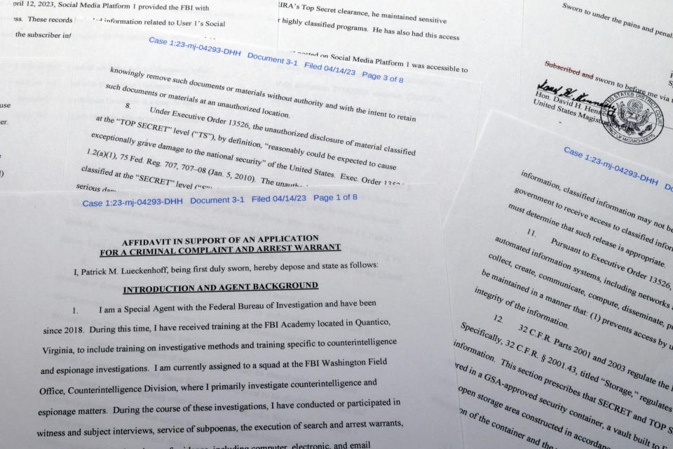 The affidavit in support of a criminal complaint and arrest warrant against Jack Teixeira is photographed Friday, April 14, 2023. The Massachusetts Air National Guardsman appeared in court in Boston, accused in the leak of highly classified military documents. (AP Photo/Jon Elswick)