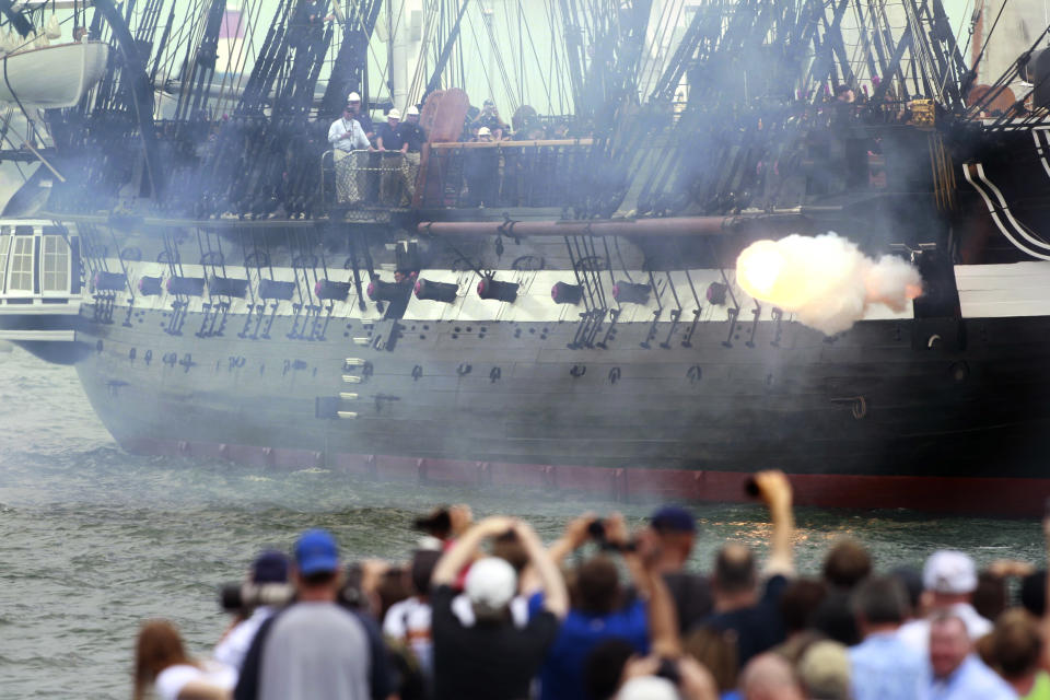 The USS Constitution fires one of her guns in Boston Harbor as a crowd looks on from the shore in Boston, Sunday, Aug. 19, 2012. The USS Constitution, the U.S. Navy's oldest commissioned war ship, sailed under her own power Sunday for the first time since 1997. The event was held to commemorate the 200th anniversary of the ship's victory over HMS Guerriere in the War of 1812. (AP Photo/Steven Senne)