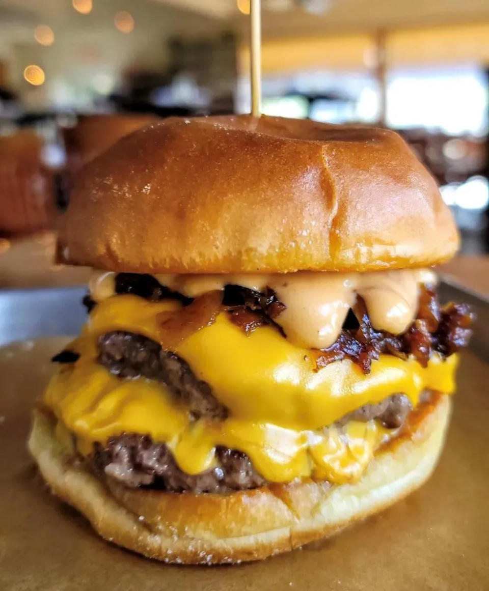 The “BAMF Burger” ($18) at South Fork Kitchen & Bar in Stuart. It’s served with bacon-onion jam, chipotle aioli and American cheese, as well as hand-cut fries.