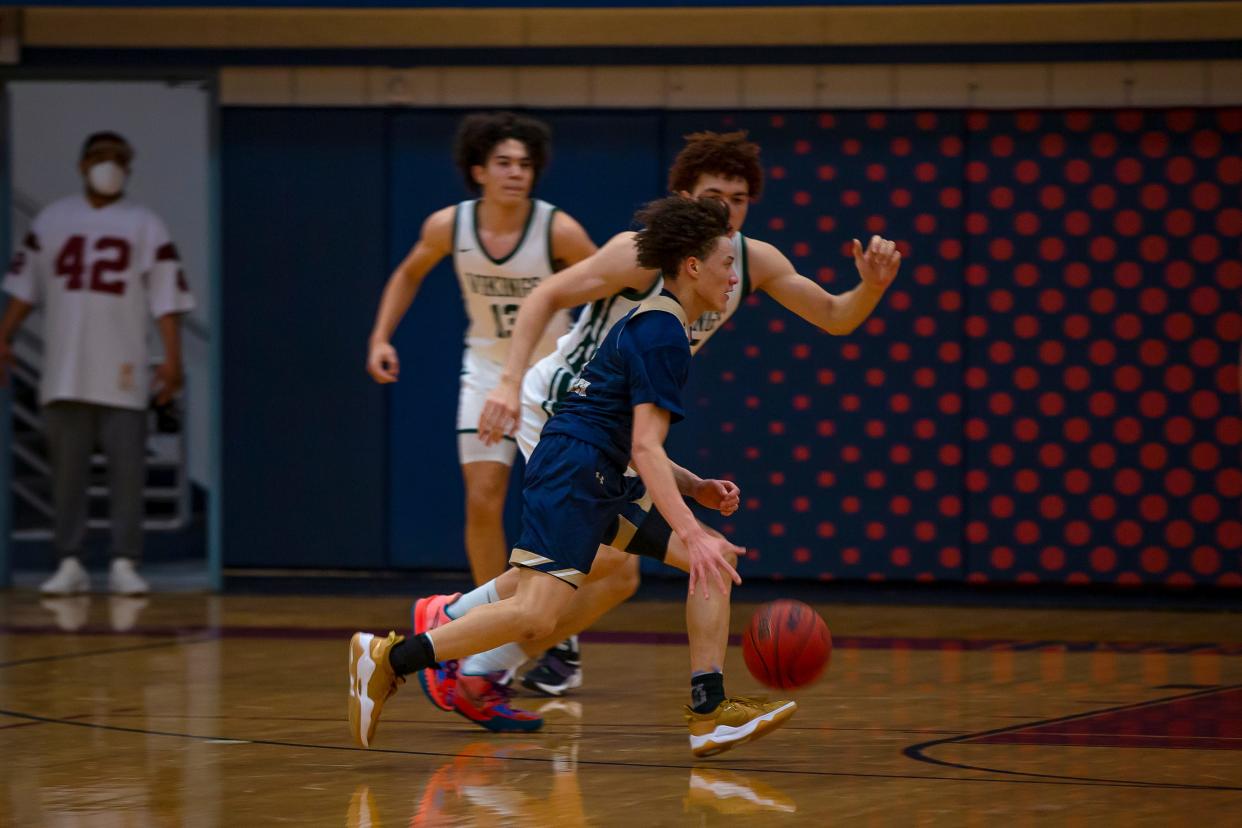 Desert Vista's Isaiah Velez runs past Sunnyslope's Elijah Saunders and Marcus Heatherly  in the MLK Dream Classic, hosted at McClintock High School in Tempe on Jan. 17, 2022.