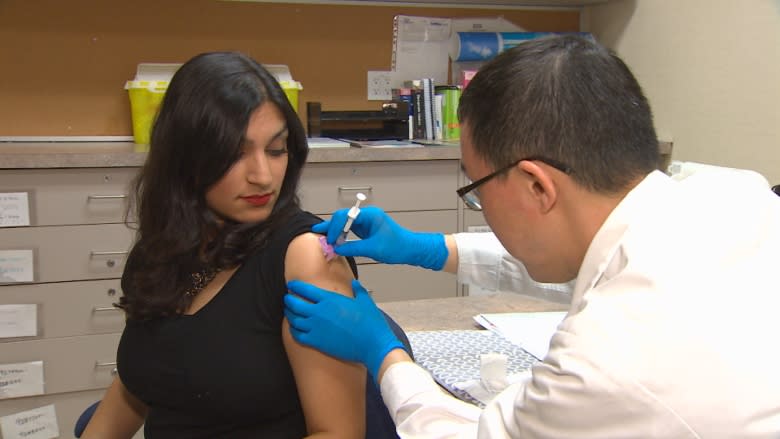 CBC's Farrah Merali gets a flu shot on Jan. 11, 2014. Pharmacists across B.C. are reporting that they are running out of the season's vaccine.