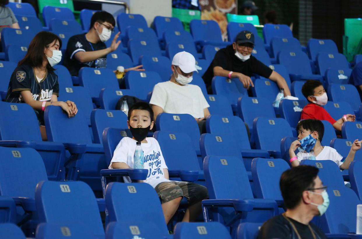 Fans sit apart in the stands for the baseball game at Xinzhuang Baseball Stadium in New Taipei City, Taiwan on May 8, 2020. Up to 1,000 spectators are now allowed in the stands for baseball in Taiwan on Friday, but they are still barred from bringing in food and concession stands are still closed.