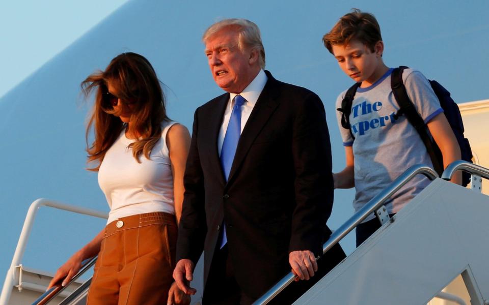 Donald Trump with First Lady Melania Trump and their son Barron arrive at Joint Base Andrews outside Washington, US, after a weekend at Trump National Golf Club in Bedminster, New Jersey - Credit: YURI GRIPAS/ REUTERS