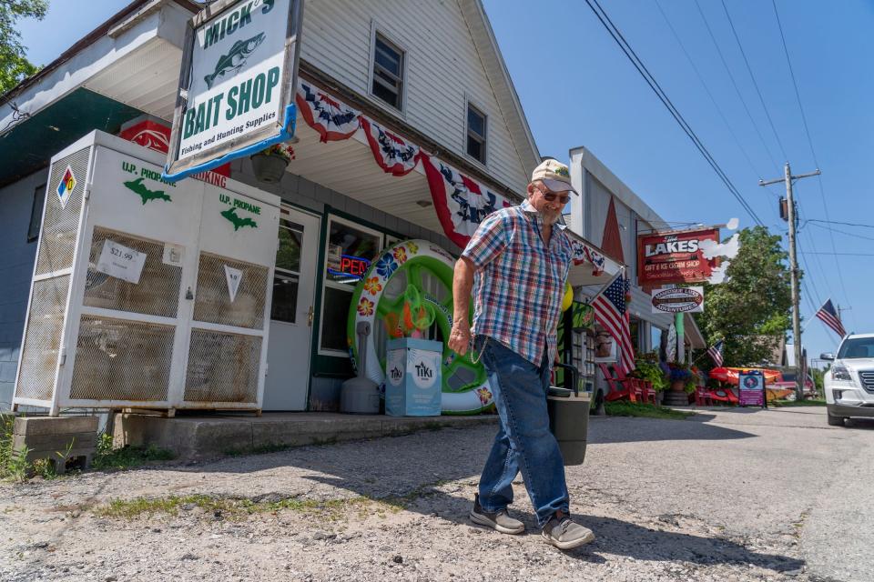 Don Peter of Germfask carries a cooler of minnows from Mick's Bait Shop as he heads out for an afternoon of fishing in Curtis, in Michigan's Upper Peninsula, on Tuesday, July 25, 2023.
