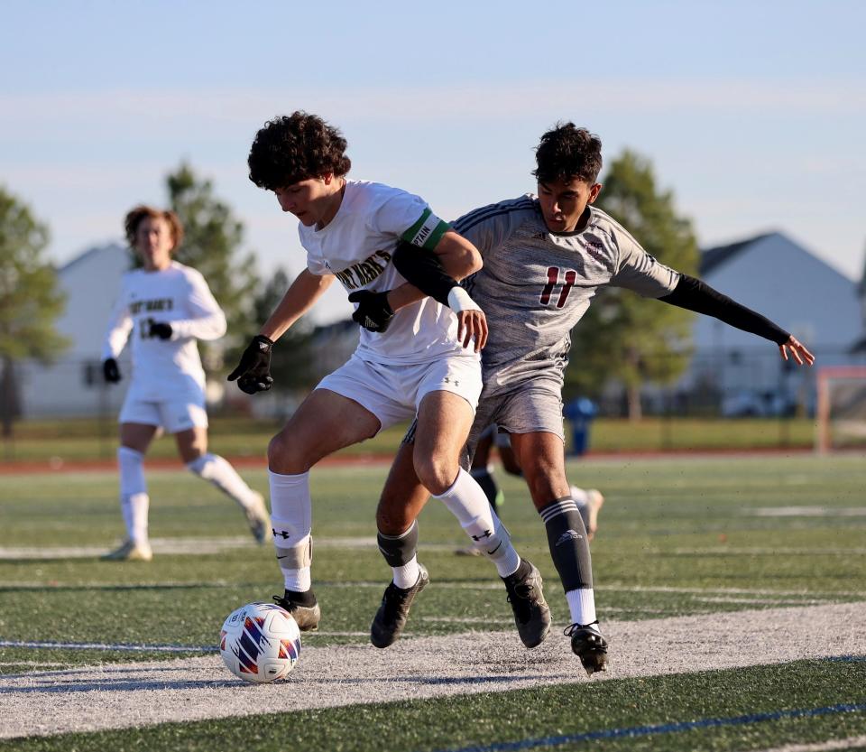 Caravel's Zayd Akhtar (11) tries to take the ball away from a Saint Mark's defender during the Buccaneers' 4-0 victory in the final of the DIAA Division II Boys Soccer Tournament on Saturday at Dover High.