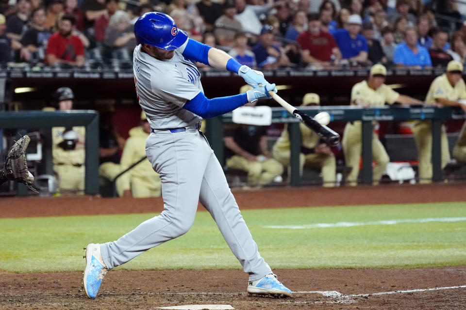 Chicago Cubs' Ian Happ connects for a grand slam against the Arizona Diamondbacks during the seventh inning of a baseball game Tuesday, April 16, 2024, in Phoenix. (AP Photo/Ross D. Franklin)