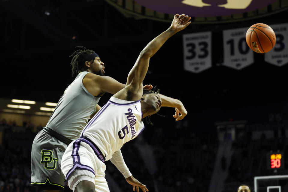 Kansas State guard Cam Carter (5) is fouled by Baylor forward Flo Thamba, left, during the first half of an NCAA college basketball game, Tuesday, Feb. 21, 2023, in Manhattan, Kan. (AP Photo/Colin E. Braley)