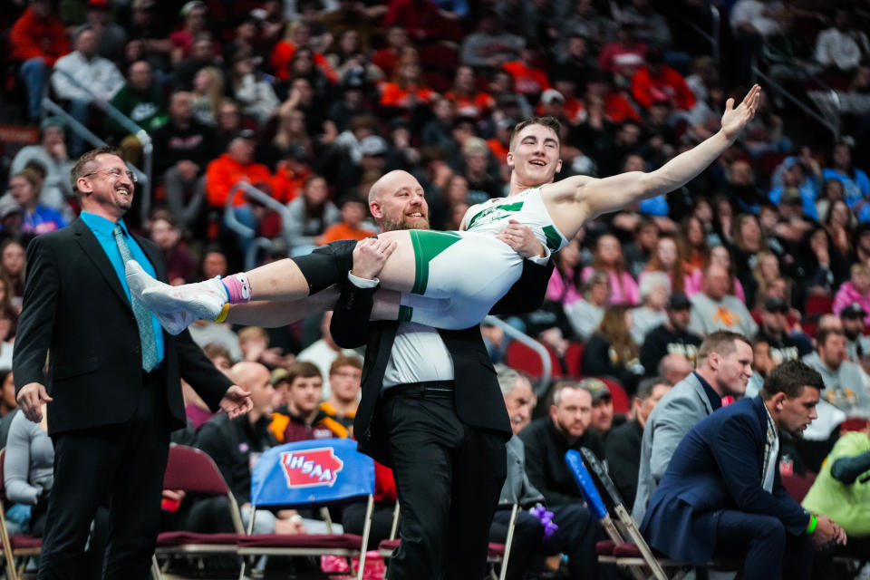 Waterloo Columbus Catholic's Max Magayna celebrates his 170-pound state title with his coach on Saturday at Wells Fargo Arena.