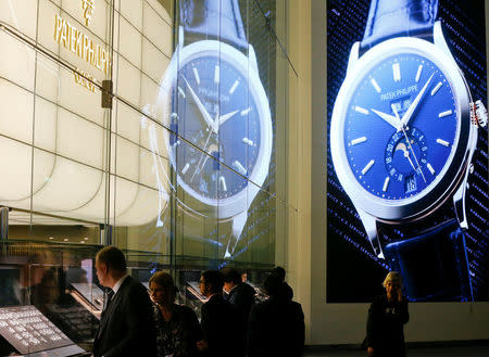 Visitors stand in front of the exhibition stand of Swiss watch manufacturer Patek Philippe at the Baselworld Watch and Jewellery Show in Basel, Switzerland March 23, 2017. REUTERS/Arnd Wiegmann