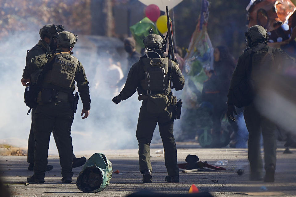 Police officers confront protesters during a demonstration in opposition to a new police training center, Monday, Nov. 13, 2023, in Atlanta. (AP Photo/Mike Stewart)