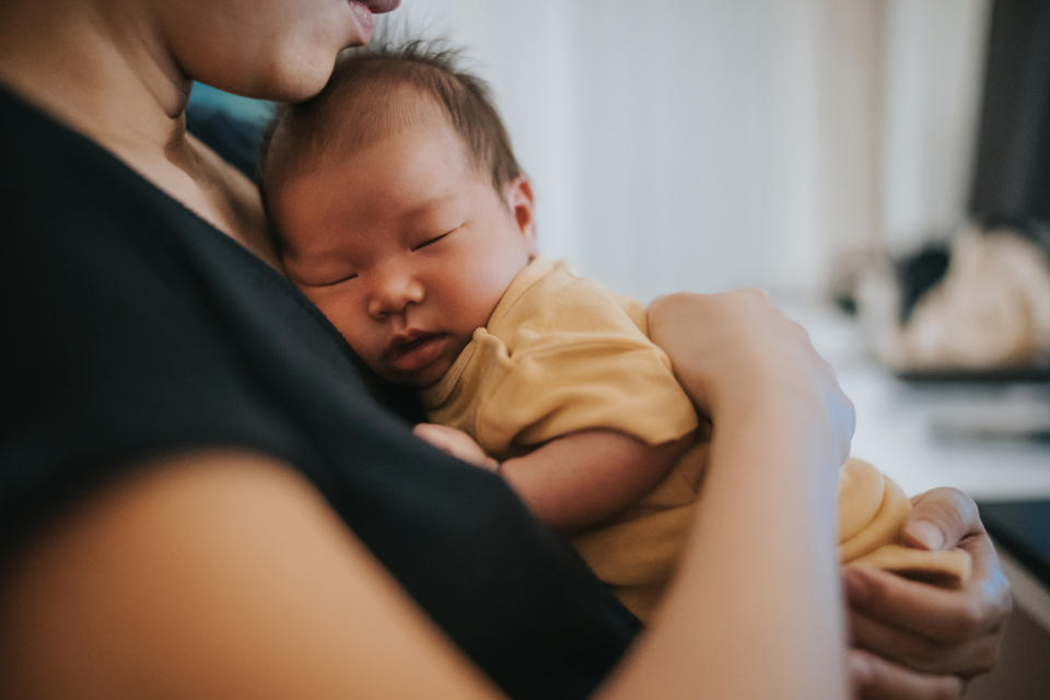 woman holding a newborn baby