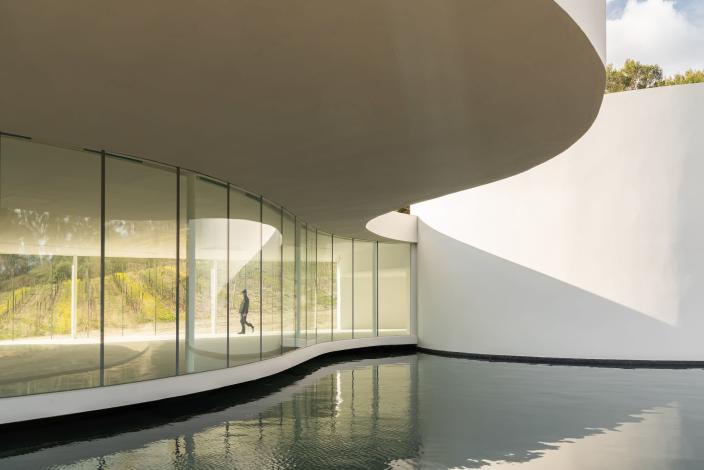 Oscar Niemeyer’s pavilion at Château La Coste consists of an exhibition space and auditorium.  The modern building is a classic Niemeyer design with curved architecture and an abundance of glass.