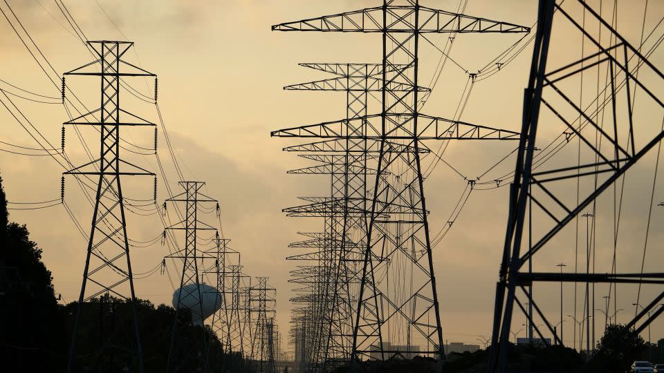 The sun rises over power lines in Houston.  - David J. Phillip/AP