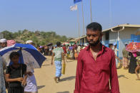 In this Wednesday, April 1, 2020, photo, Rohingya refugee Sagir Ahmed, 33, stands at the Kutupalong refugee camp, Cox’s Bazar, Bangladesh. "People have been waiting in queues for aid for a whole week. They will definitely get sick in this situation. The relief work isn't being done here. So, people are going to die anyway from diseases," he said. Aid workers are bracing for a possible outbreak of the coronavirus in one of the world's largest refugee camps in Bangladesh, but officials are already warning that containing the disease among more than 1 million tightly packed Rohingya Muslims will be a daunting task. (AP Photo/Suzauddin Rubel)