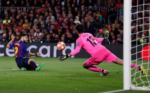 Barcelona's Luis Suarez, left, scores his side's first goal passing Liverpool goalkeeper Alisson - Credit: AP Photo/Manu Fernandez