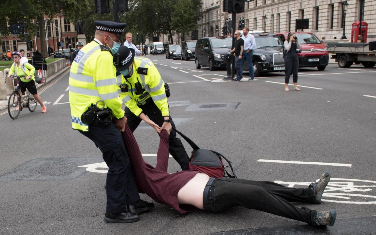 Extinction Rebellion protesters deliberately go floppy when they are arrested - Stefan Rousseau/PA