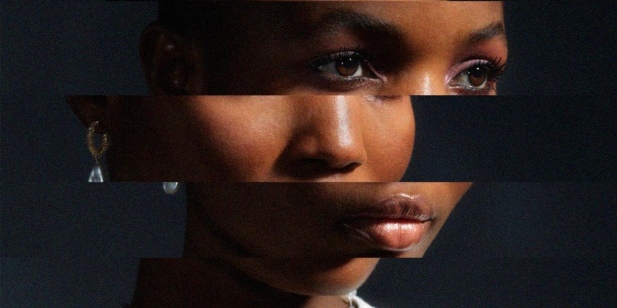 a young black womans face is distorted