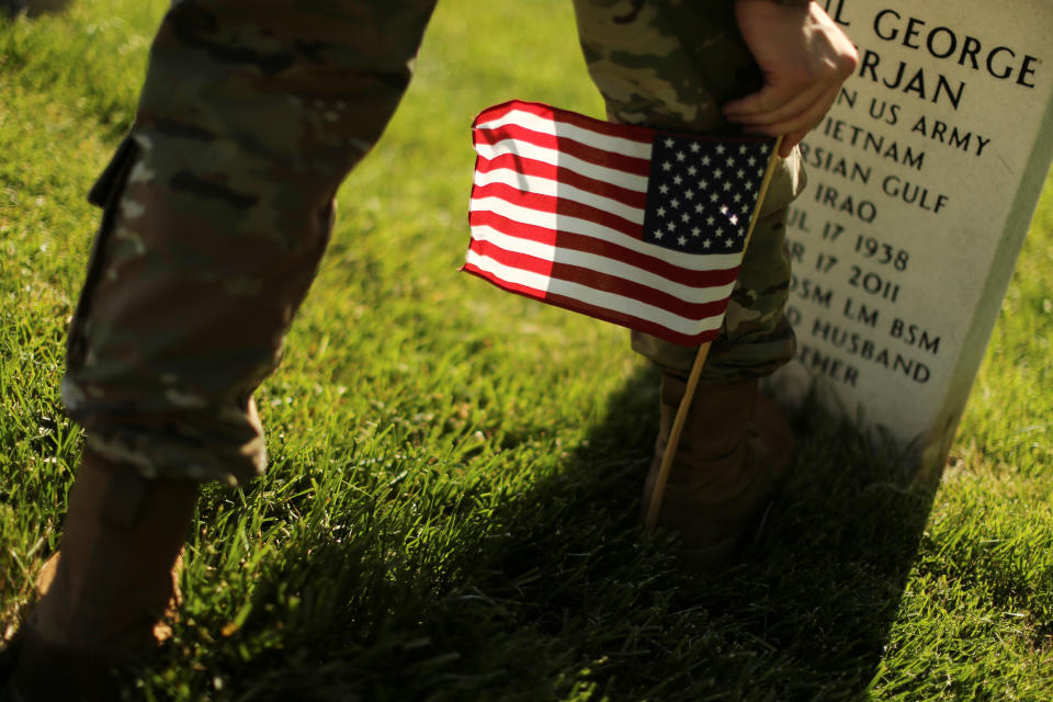 <p>A U.S. Army soldier of the 3rd United States Infantry Regiment uses his boot to measure where to place U.S. flags on graves at Arlington National Cemetery in advance of Memorial Day in Arlington, Va., May 24, 2018. (Photo: Jonathan Ernst/Reuters) </p>