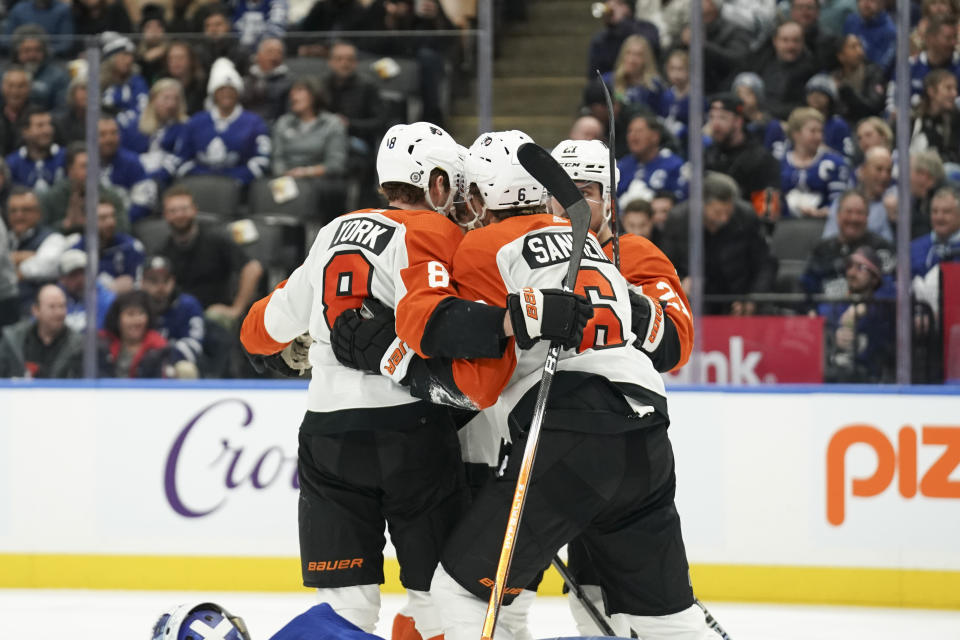 Philadelphia Flyers defenseman Travis Sanheim (6) celebrates his goal against the Toronto Maple Leafs with teammates during the first period of an NHL hockey game Thursday, Feb. 15, 2024, in Toronto. (Arlyn McAdorey/The Canadian Press via AP)