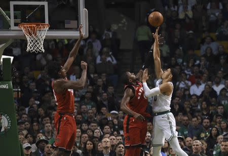 Nov 12, 2017; Boston, MA, USA; Boston Celtics forward Jayson Tatum (0) shoots the ball over Toronto Raptors forward CJ Miles (0) during the second half at TD Garden. Bob DeChiara-USA TODAY Sports