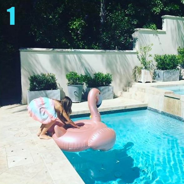 Sofia Vergara crouches at the edge of the pool, feet on dry land, hands on float.