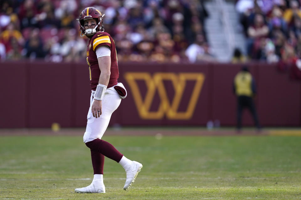 Washington Commanders quarterback Carson Wentz (11) walks to the sideline during the second half of an NFL football game against the Cleveland Browns, Sunday, Jan. 1, 2023, in Landover, Md. (AP Photo/Patrick Semansky)