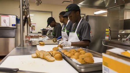 Students prepare food in a kitchen in this July 18, 2013 handout photo provided by Liberty's Kitchen in New Orleans, Louisiana, March 3, 2015. REUTERS/Liberty's Kitchen/Handout via Reuters