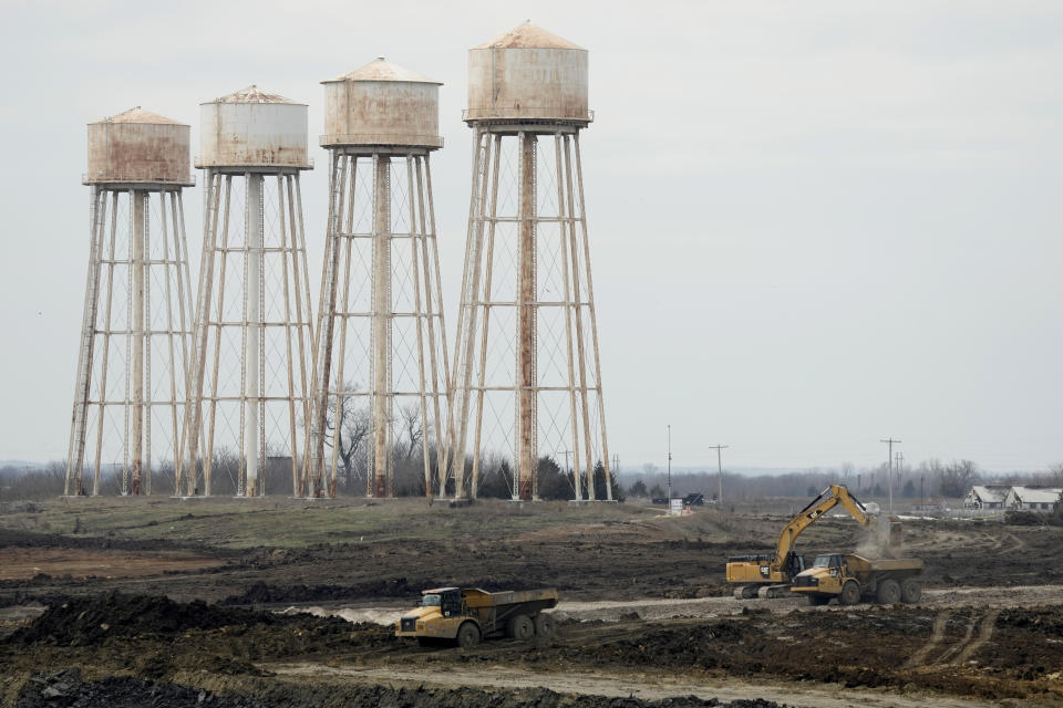 Workers prepare the site of a $4 billion Panasonic EV battery plant Thursday, March 30, 2023, near DeSoto, Kan. Economic incentives offered by Kansas state and local governments beat out those offered by neighboring Oklahoma to help lure the project to the site on land formerly occupied by an Army ammunition plant. (AP Photo/Charlie Riedel)