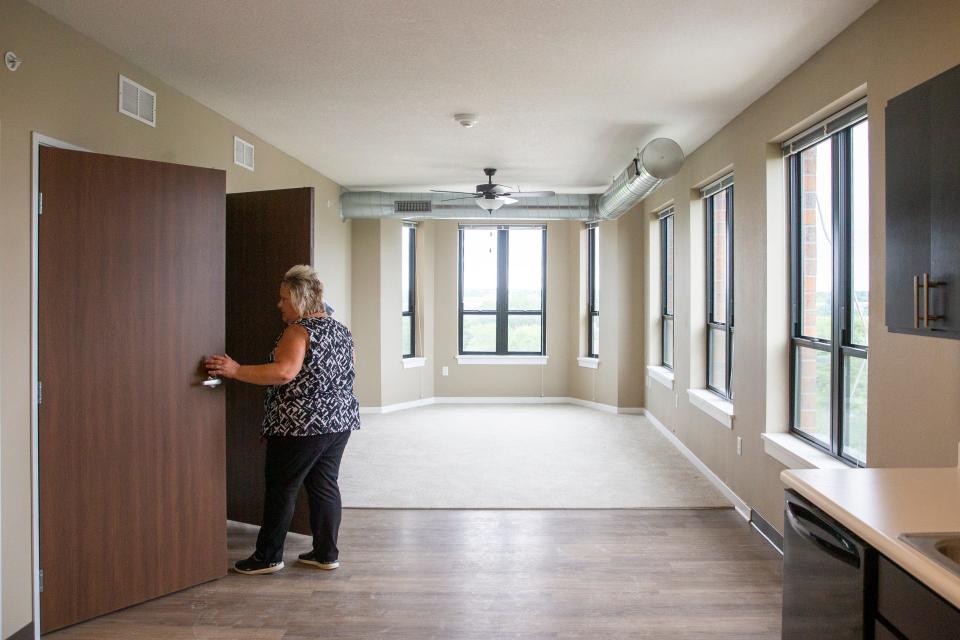 People take a closer look at a two-bedroom unit during the grand opening of the Sixth Avenue Flats on Thursday in Des Moines. Sixth Avenue Flats, an affordable apartment in which some units are reserved for youth who have aged out of foster care, is located at 1230 Sixth Ave.