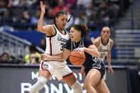 Georgetown's Kelsey Ransom, right, dribbles around UConn's Azzi Fudd, left, in the first half of an NCAA college basketball game, Sunday, Jan. 15, 2023, in Hartford, Conn. (AP Photo/Jessica Hill)