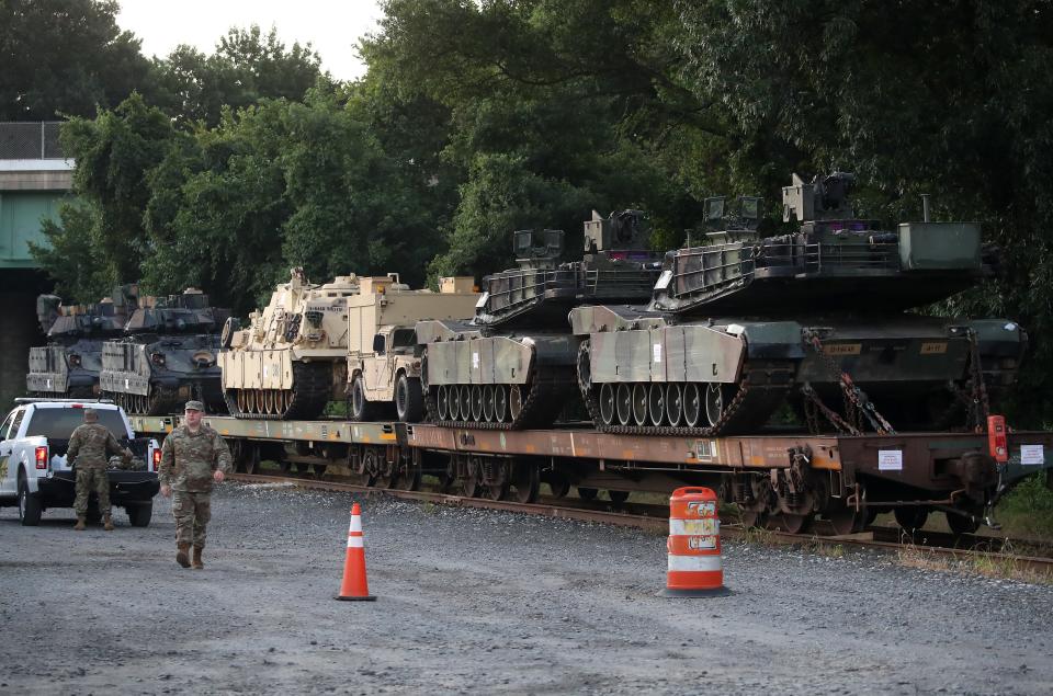 Two M1A1 Abrams tanks and other military vehicles sit on guarded rail cars at a rail yard on July 2, 2019, in Washington, DC. President Trump asked the Pentagon for military hardware, including tanks, to be displayed during the 4th of July Salute To America on the National Mall.