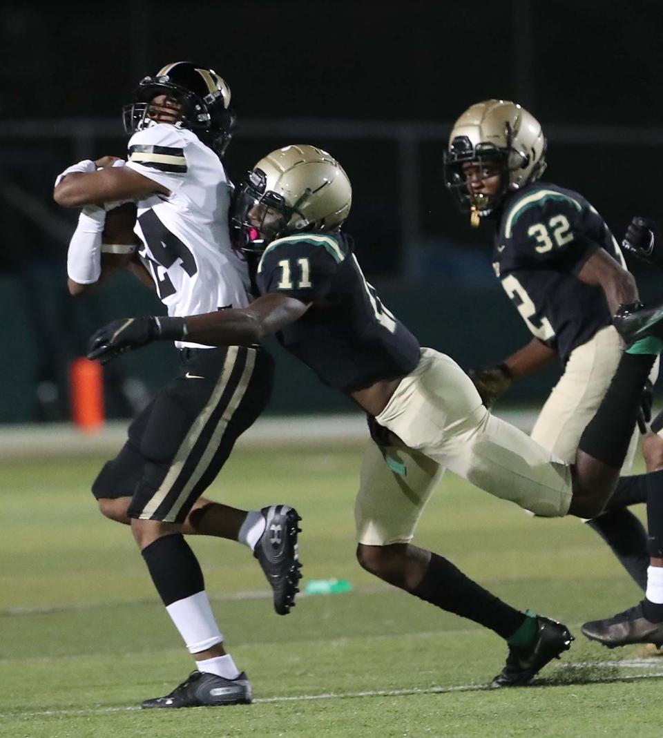 Warren Harding's Tariq Ivory, left is tackled by St. Vincent-St. Mary's SirCharles Gordon on Sept. 24, 2021. Now a senior, Gordon is expected to be a standout wide receiver for the Irish.