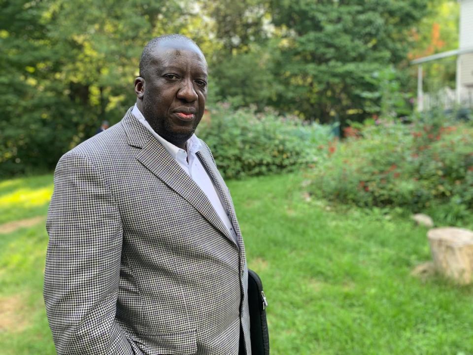 All charges have been withdrawn against Dr. Jean-Robert Ngola, who was accused of violating the Emergency Measures Act for not quarantining. He is now suing. (Judy Trinh/CBC News file photo - image credit)