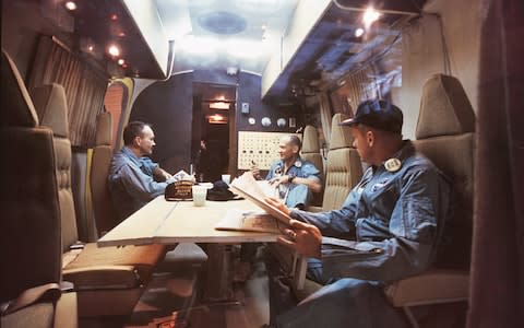 Armstrong (right), Aldrin and Collins inside the quarantine vehicle – where they stayed for 21 days - Credit: GETTY IMAGES