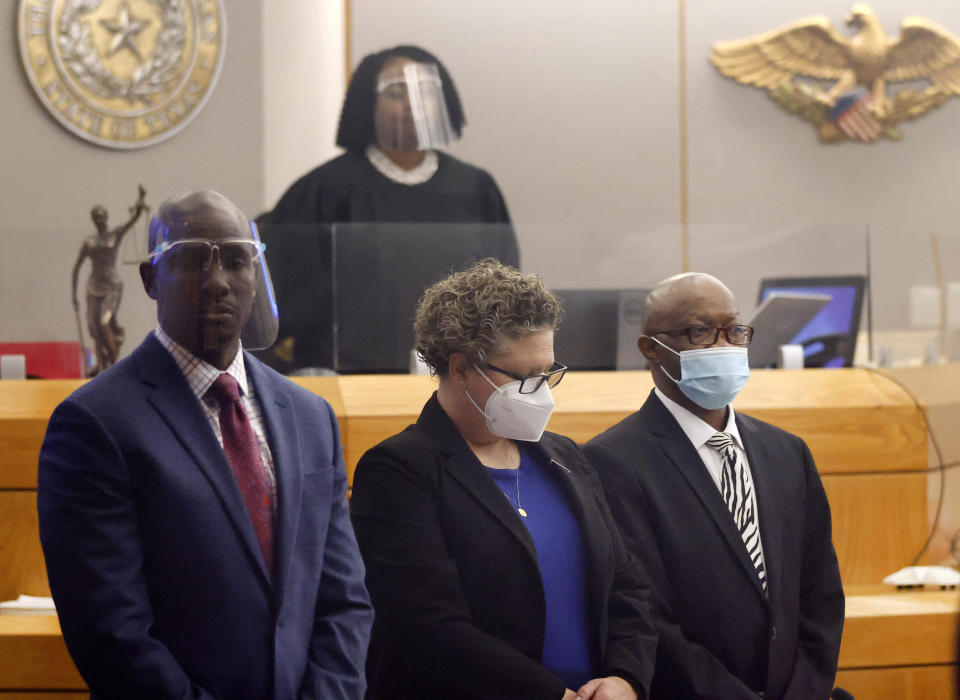 Billy Chemirmir, right, flanked by private investigator Tonia Silva, center, and his defense attorney Kobby Warren, as his murder trial gets underway at the Frank Crowley Courts Building in Dallas, Monday, Nov. 15, 2021. Chemirmir is charged with killing 18 older women in Dallas and its suburbs over a two-year span. (Tom Fox/The Dallas Morning News via AP, Pool)